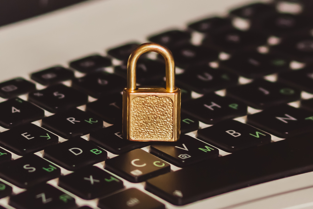 metal lock placed on laptop keyboard