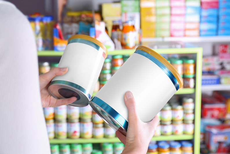 woman with cans of baby food in store