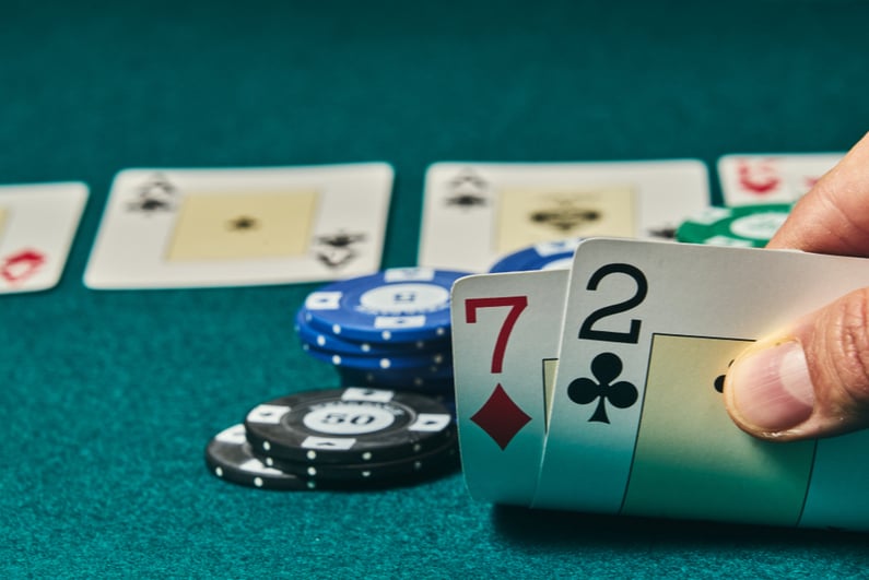 Poker player holding 2-7 offsuit